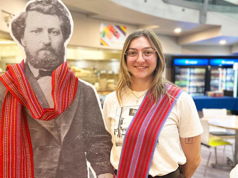 Paris Gauthier, debout près d'une découpe cartonnée de Louis Riel.